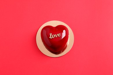 St. Valentine's Day. Delicious heart shaped cake on red background, top view