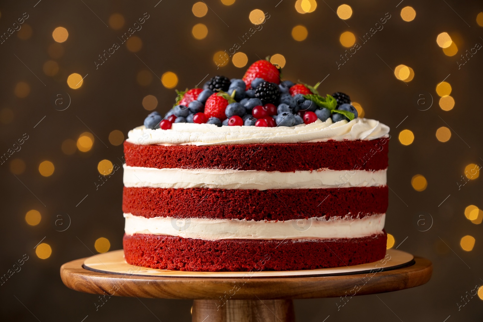 Photo of Delicious homemade red velvet cake against blurred lights