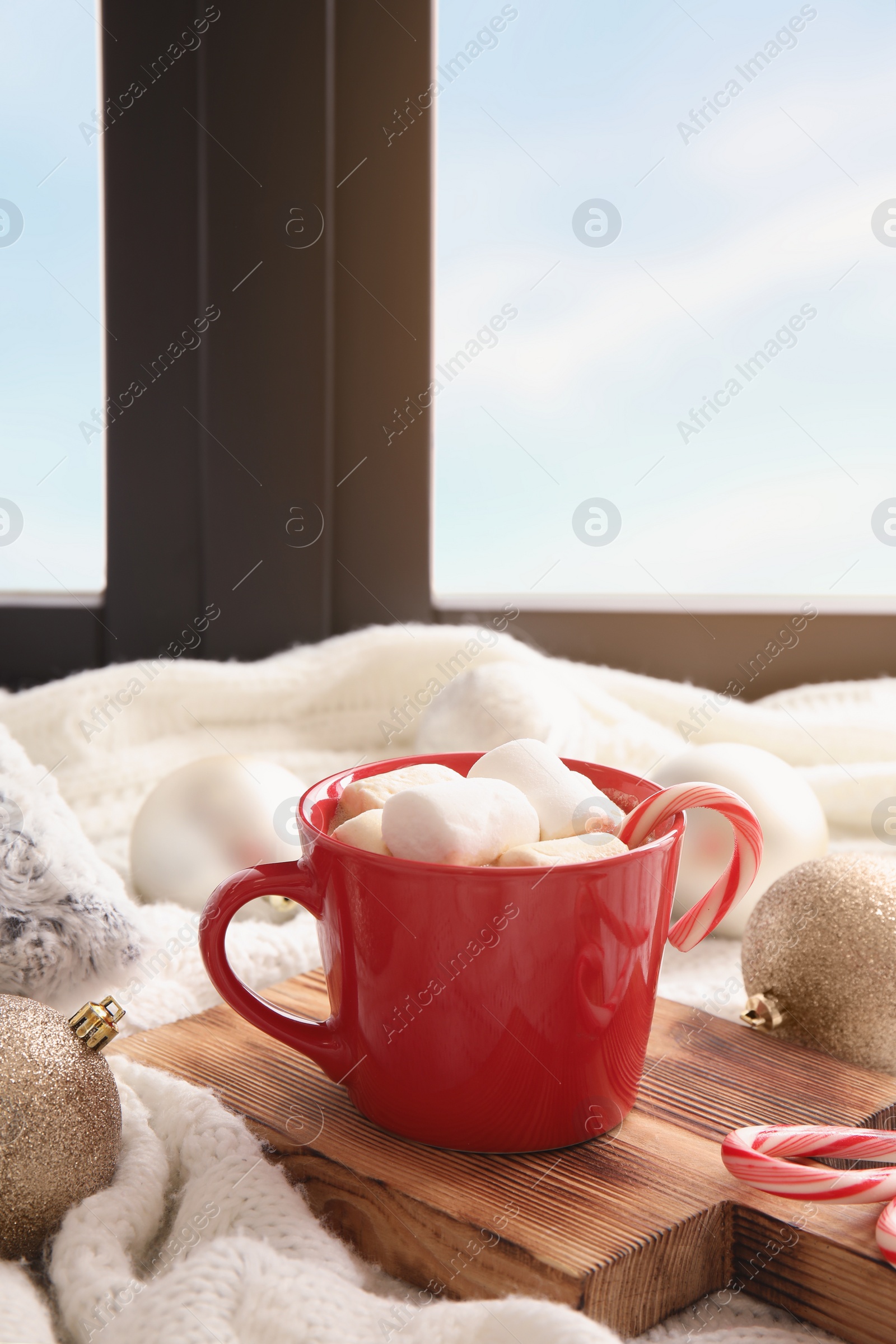 Photo of Composition with cup of hot winter drink near window. Cozy season