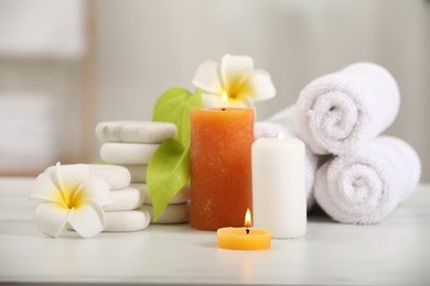 Photo of Composition with different spa products and plumeria flowers on white marble table