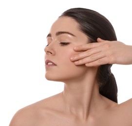 Photo of Young woman massaging her face on white background