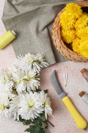 Photo of Flat lay composition with knife, threads and Chrysanthemum flowers on light textured table