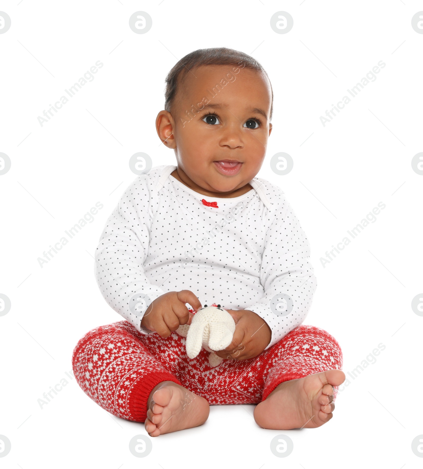 Photo of Cute African-American baby with toy on white background. First Christmas