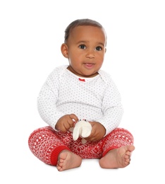 Photo of Cute African-American baby with toy on white background. First Christmas