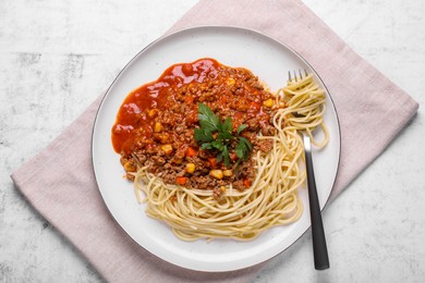 Tasty dish with fried minced meat, spaghetti, carrot and corn served on white textured table, top view