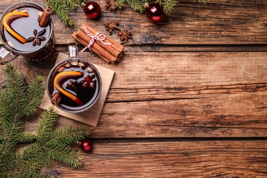 Photo of Flat lay composition with aromatic mulled wine on wooden table, space for text