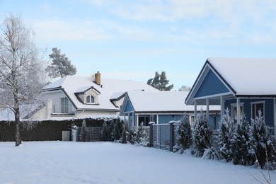Winter landscape with beautiful houses, trees and bushes in morning