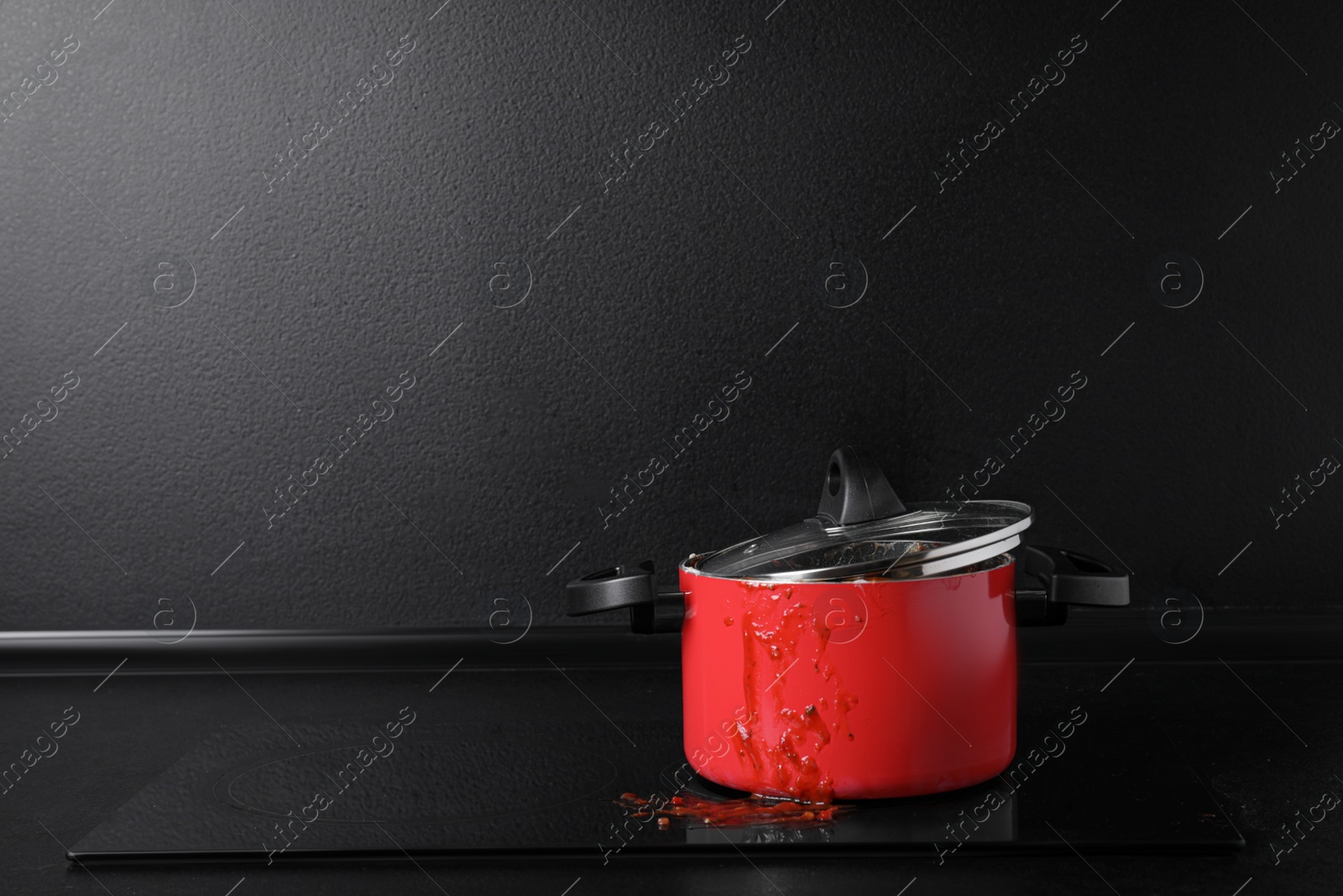 Photo of Dirty pot with lid on cooktop in kitchen, space for text