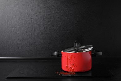 Photo of Dirty pot with lid on cooktop in kitchen, space for text