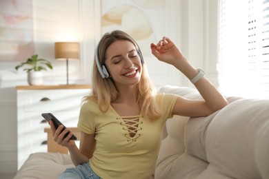 Young woman listening to music at home