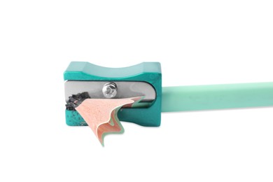 Photo of Turquoise sharpener with shavings and pencil on white background