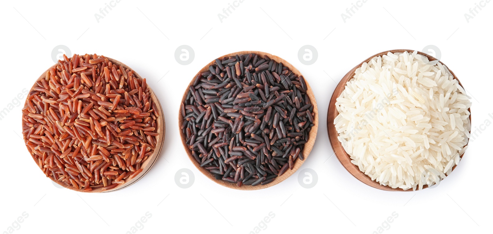 Photo of Bowls with different types of uncooked rice on white background, top view