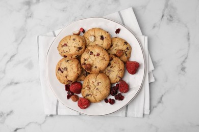 Photo of Cookies with freeze dried fruits and nuts on white marble table, top view