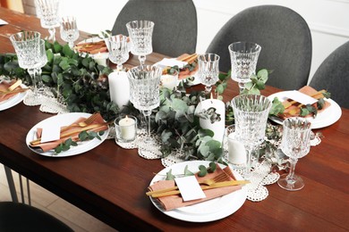 Luxury table setting with beautiful decor and blank cards indoors. Festive dinner