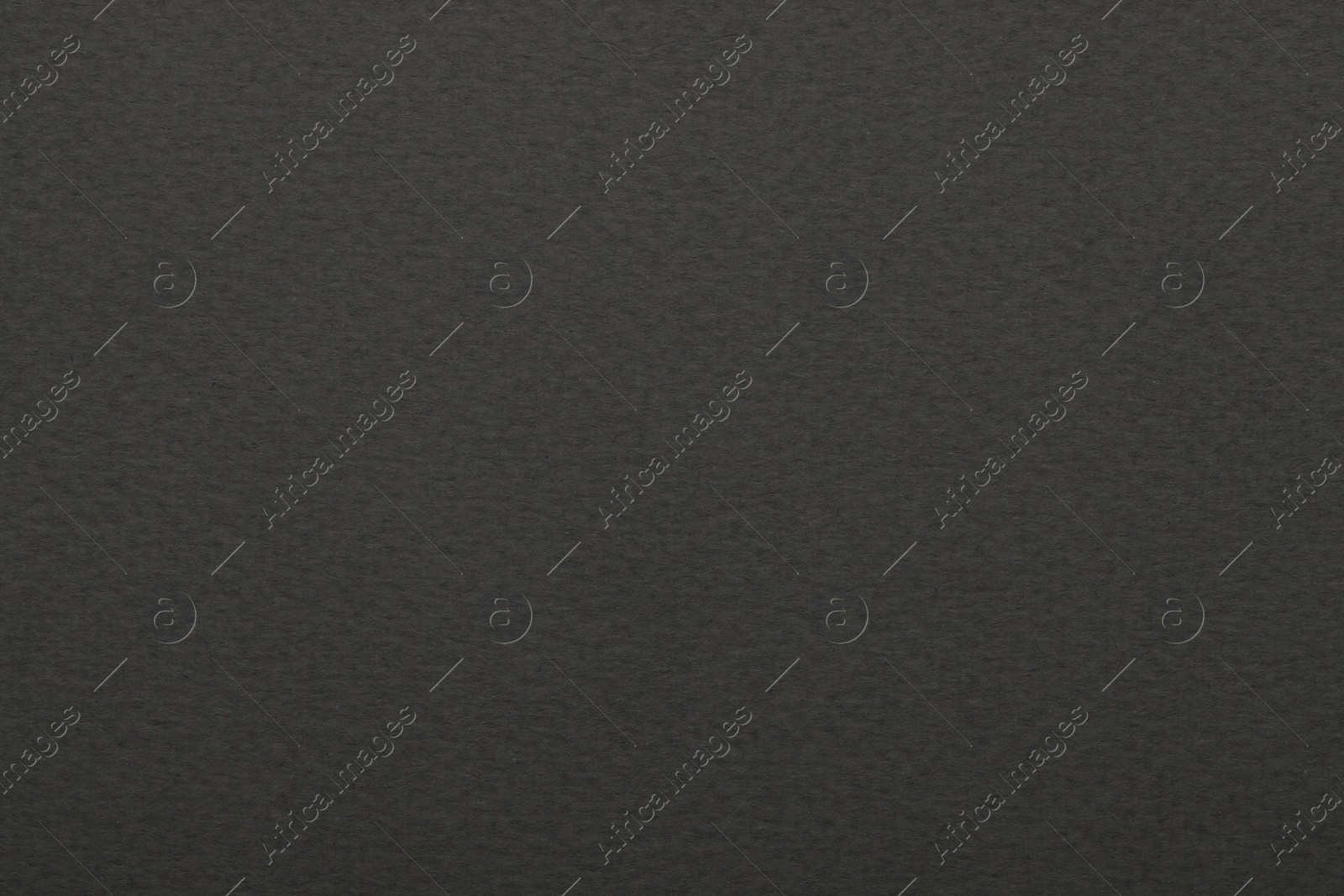 Photo of Texture of dark grey paper sheet as background, top view