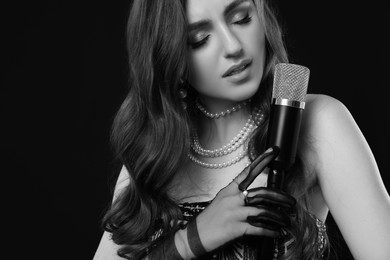 Image of Beautiful singer with microphone, black and white effect