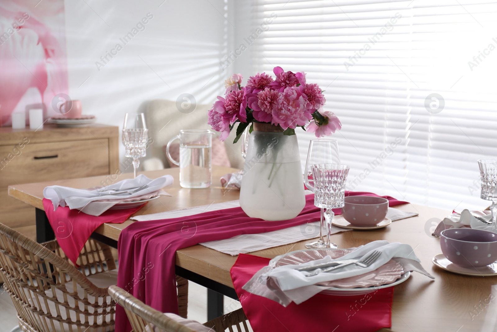 Photo of Beautiful table setting with pink peonies in dining room