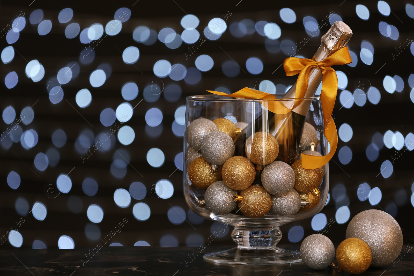 Photo of New year composition with champagne and space for text against blurred Christmas lights