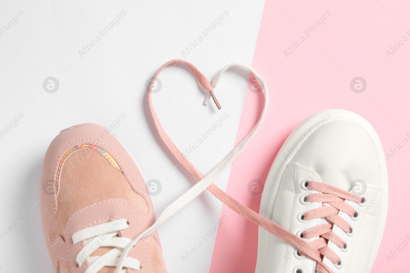 Photo of Pair of stylish shoes with laces on color background, flat lay