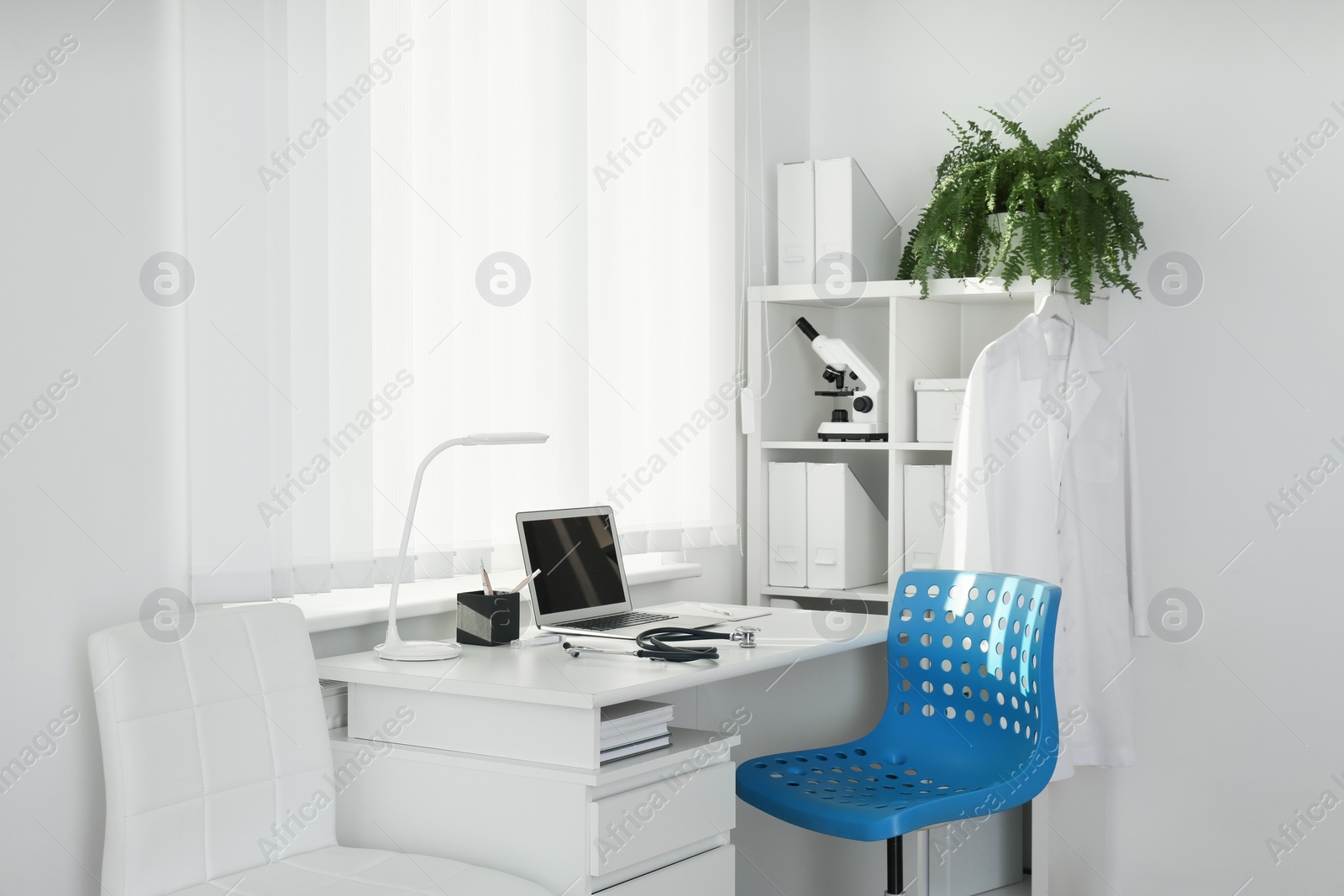 Photo of Interior of modern medical office with doctor's workplace