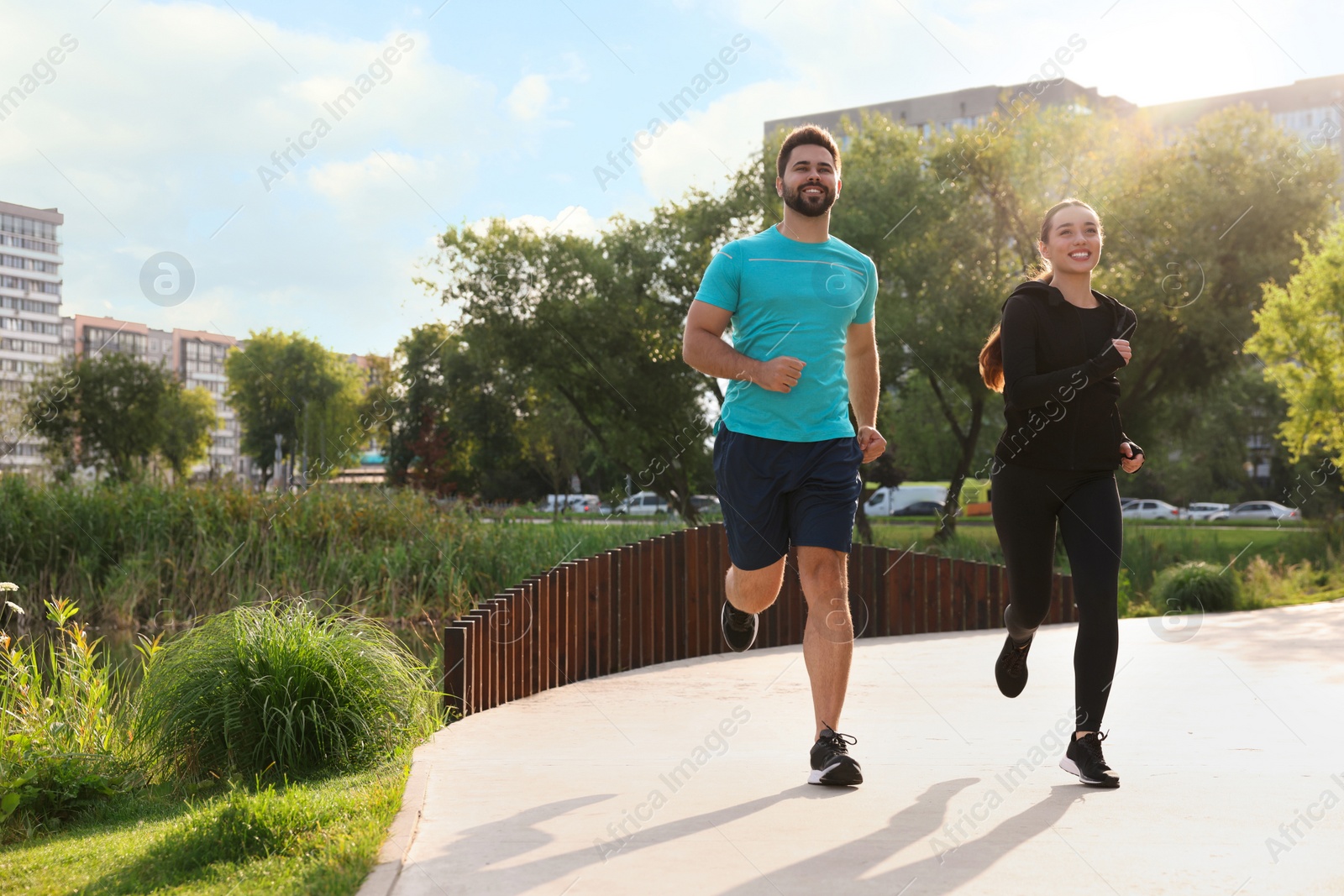 Photo of Healthy lifestyle. Happy couple running outdoors, space for text