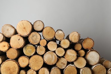 Photo of Cut firewood on grey background. Heating in winter