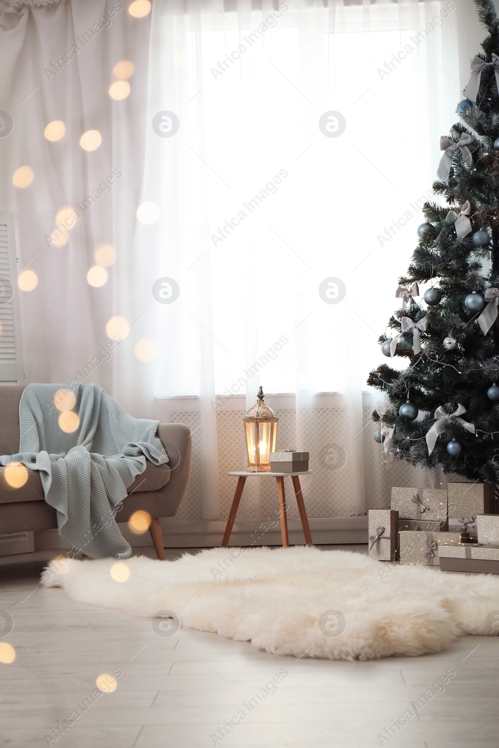 Photo of Stylish living room interior with decorated Christmas tree and blurred lights in foreground