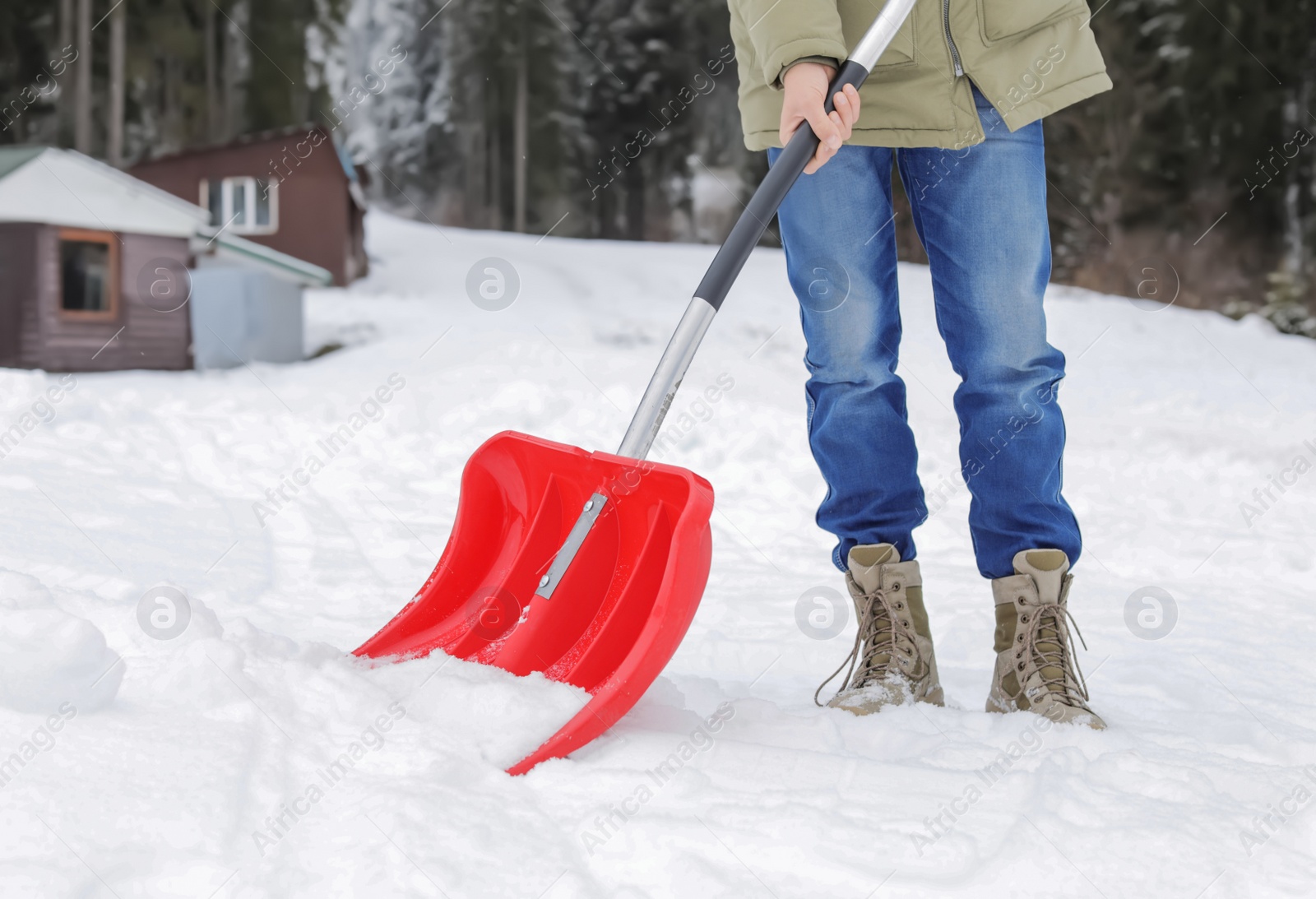 Photo of Man removing snow with shovel near house