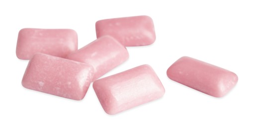 Photo of Heap of tasty sweet chewing gums on white background