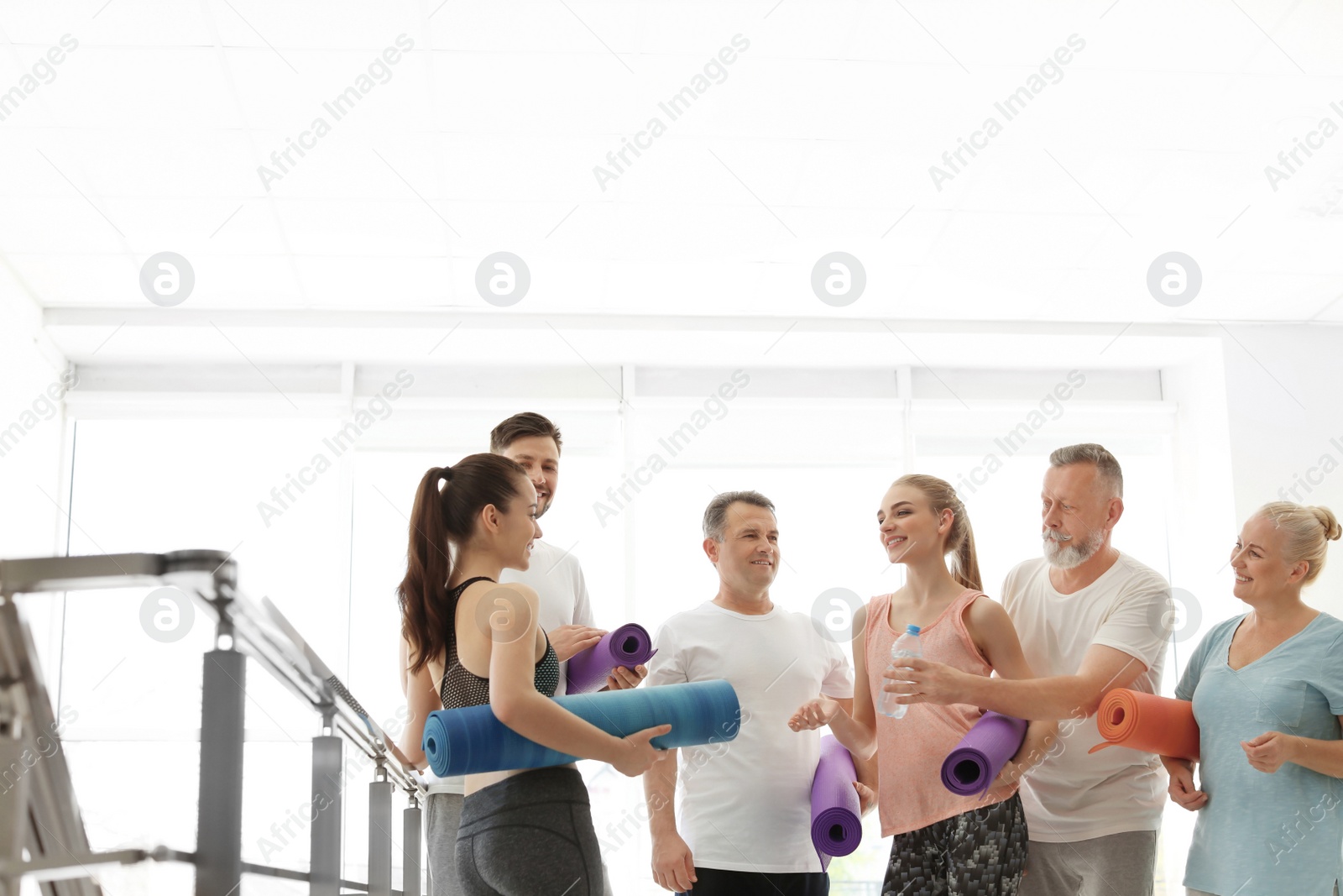 Photo of Group of people talking after yoga class indoors