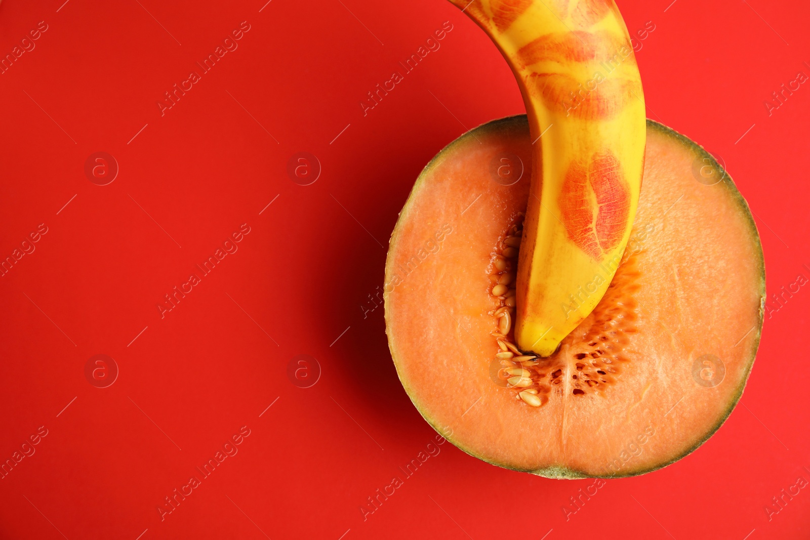 Photo of Flat lay composition with fresh banana and melon on red background. Sex concept