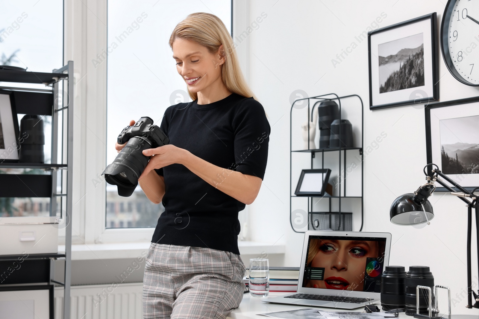 Photo of Professional photographer with modern digital camera in office