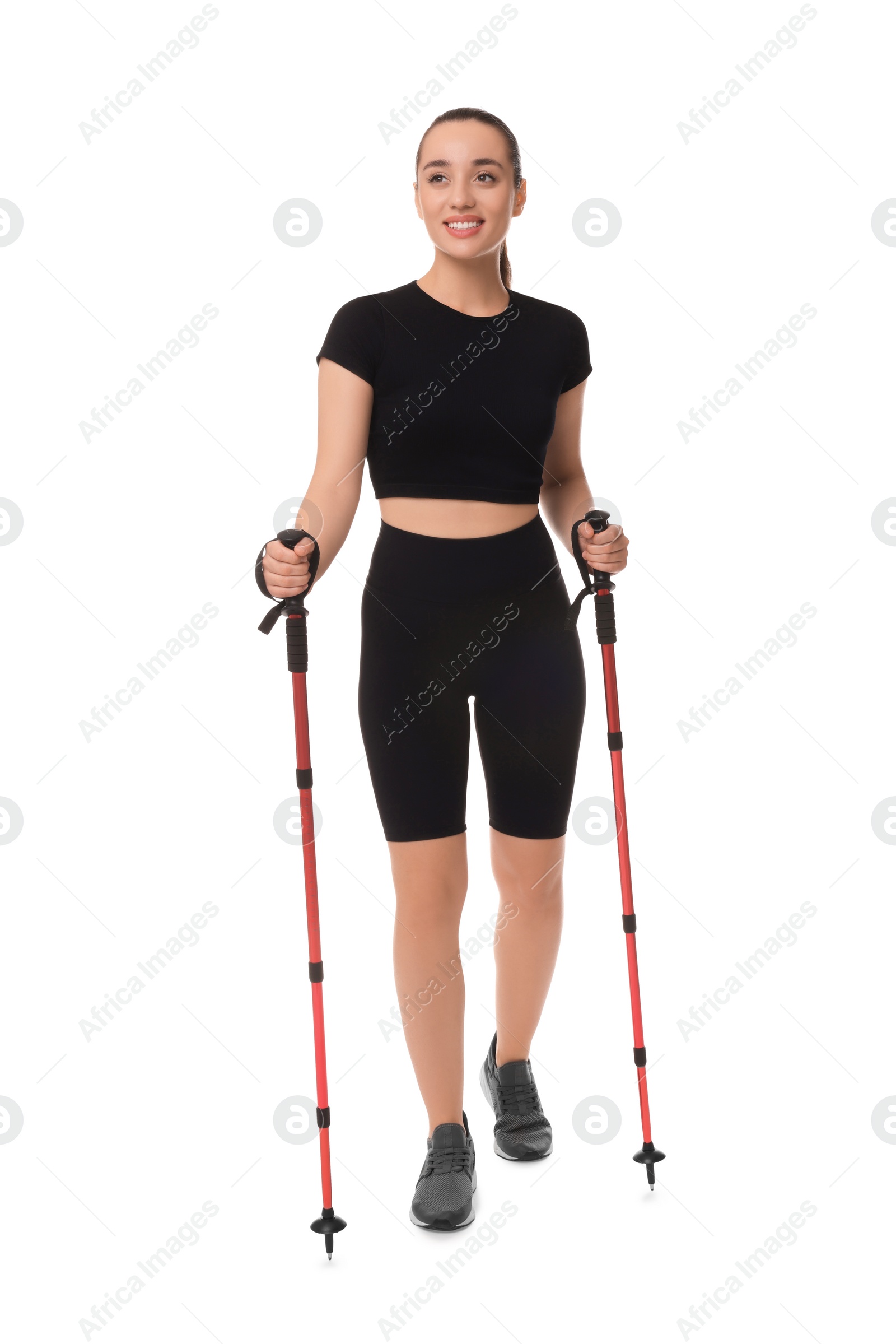 Photo of Young woman practicing Nordic walking with poles isolated on white