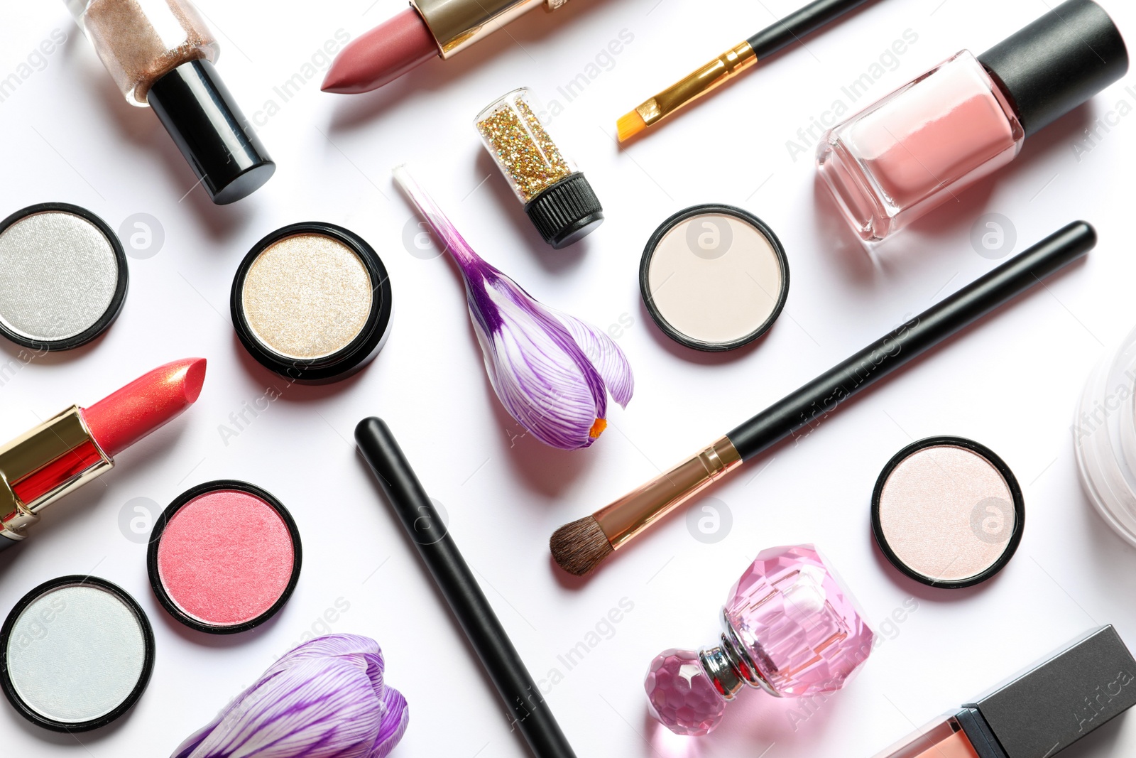 Photo of Different makeup products and flowers on white background, top view