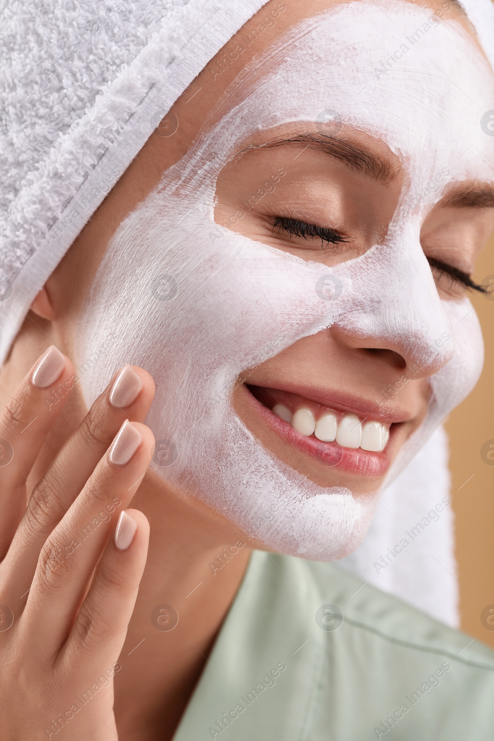 Photo of Woman with face mask on beige background, closeup. Spa treatments