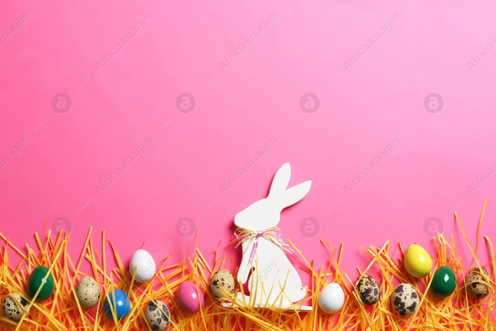 Photo of Flat lay composition of Easter bunny figure and eggs on color background, space for text