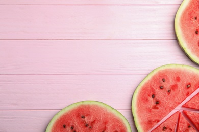 Photo of Slices of ripe watermelon on pink wooden table, flat lay. Space for text