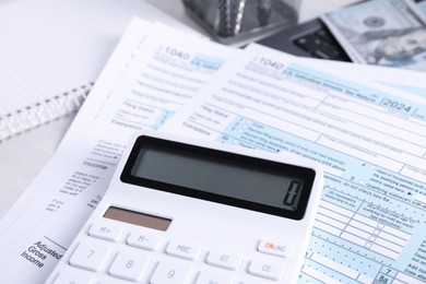 Tax accounting. Calculator and documents on table, closeup