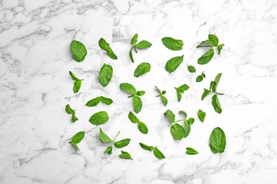 Photo of Fresh mint leaves on white marble background, flat lay