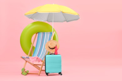 Photo of Deck chair, umbrella, suitcase and beach accessories against pink background, space for text. Summer vacation