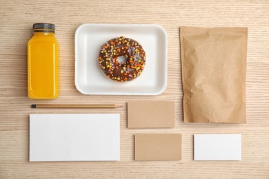 Photo of Flat lay composition with items for mock up design on wooden background. Food delivery service