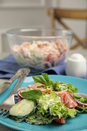 Photo of Plate of delicious vegetable salad dressed with mayonnaise served on table