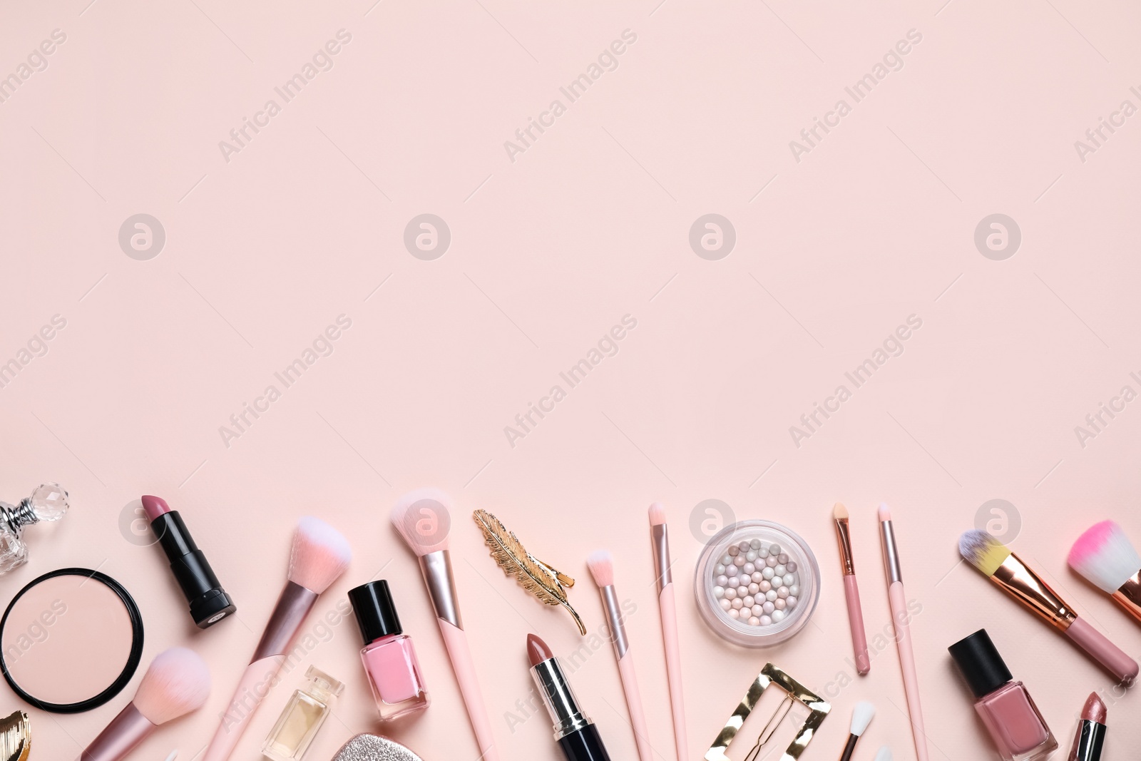 Photo of Makeup brushes and cosmetic products on beige background, flat lay. Space for text