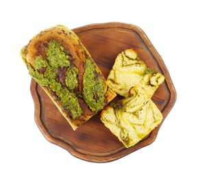 Photo of Serving board with freshly baked pesto bread isolated on white, top view