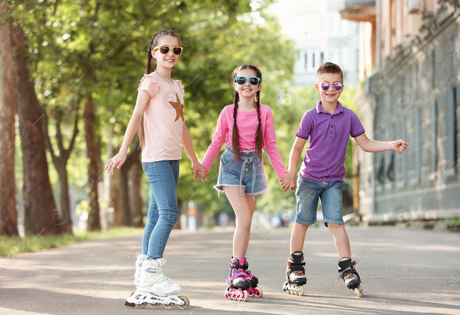 Photo of Little children roller skating on city street