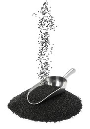 Image of Black sesame seeds falling into pile and scoop on white background