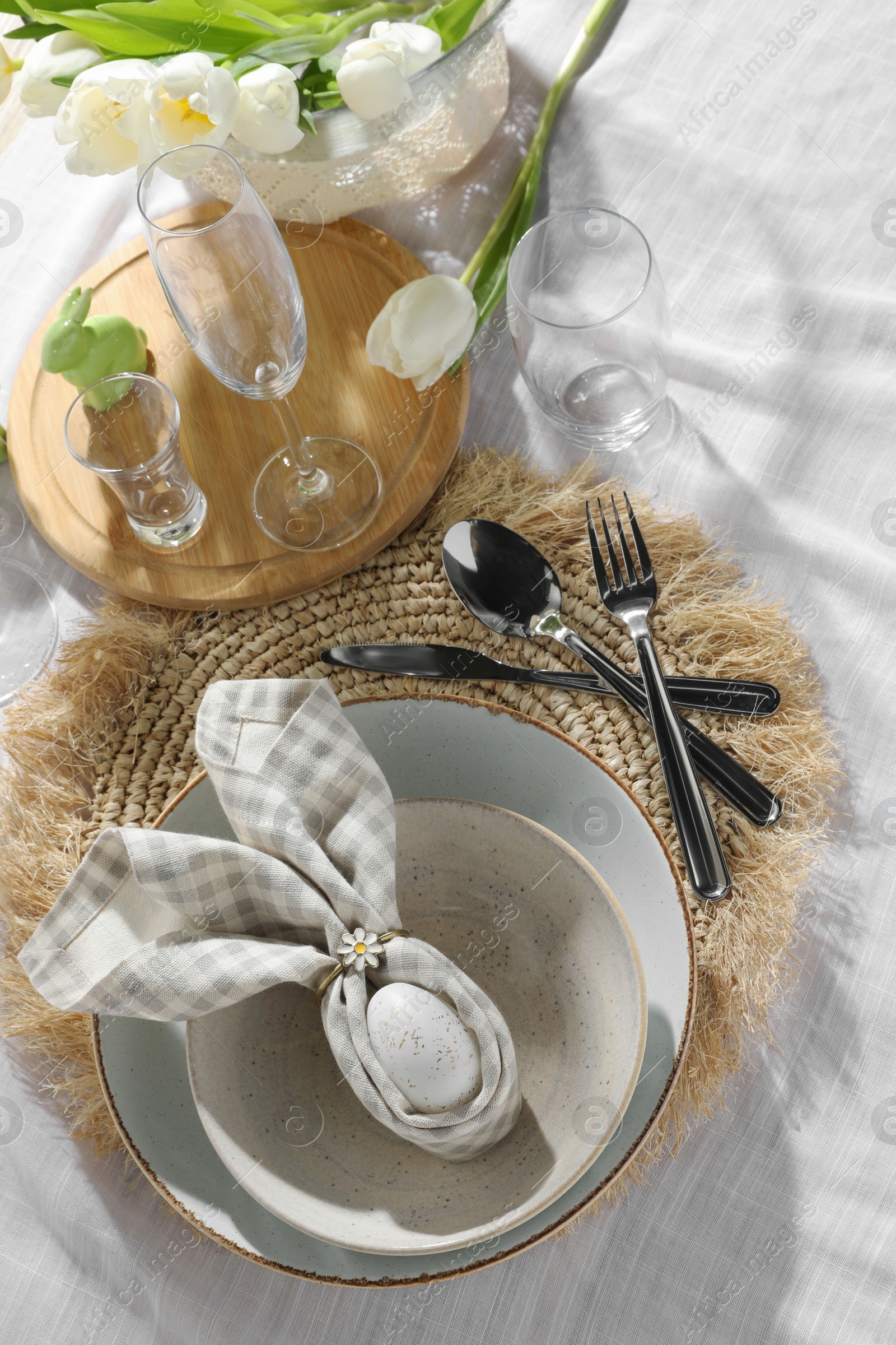 Photo of Easter table setting with bunny ears made of egg and napkin, above view