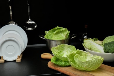Photo of Different types of cabbage on countertop in kitchen