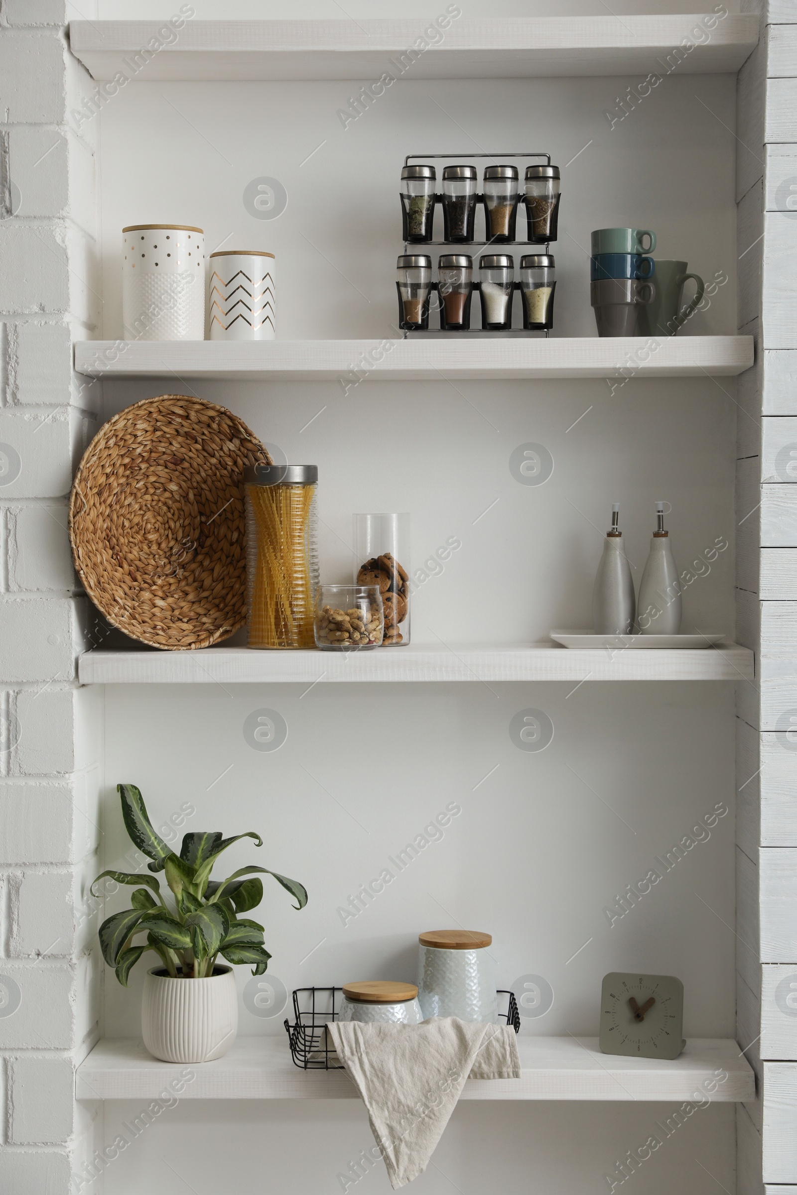 Photo of Many shelves with different decor in room. Interior design