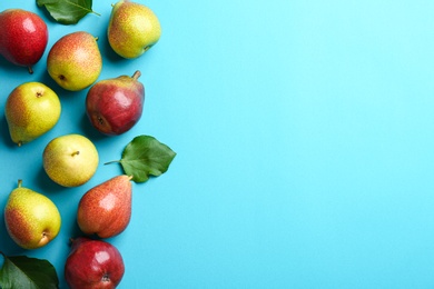 Ripe juicy pears on blue background, flat lay. Space for text